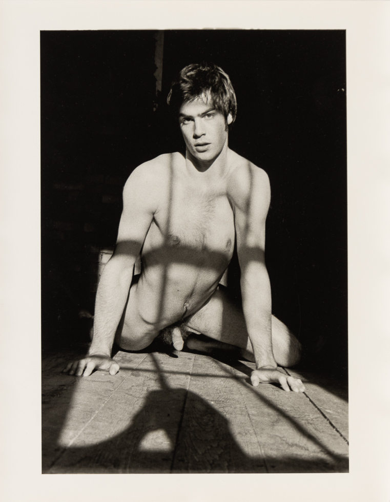 This is a vintage black and white photograph by Curtice Taylor of Alan nude in a Barn.