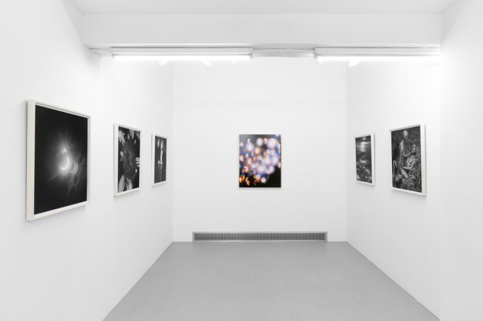 An installation view in a bright, white-walled contemporary art gallery.