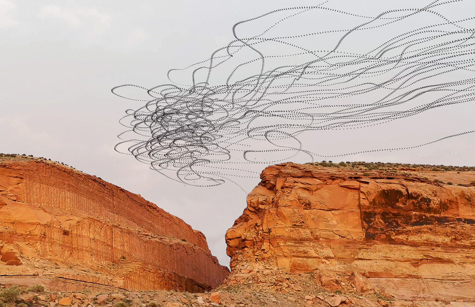 This is a color photograph of orange stone features in Moab with a flock of vultures flying above.