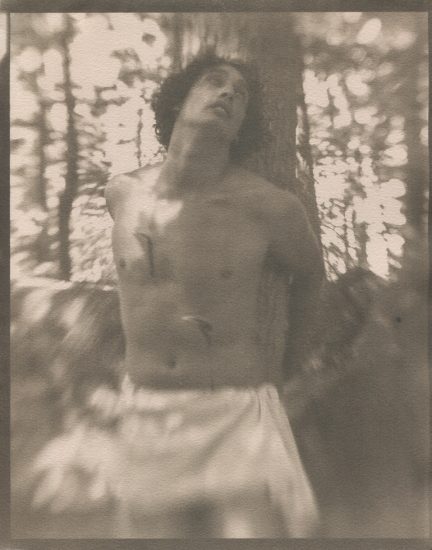 This is a black and white photograph by Curtice Taylor of a man tied to a tree entitled St. Sebastian.