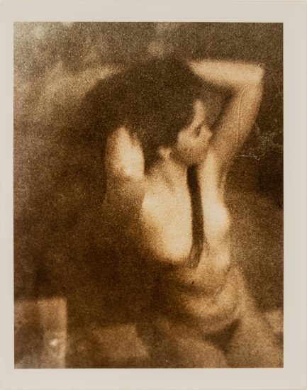 Click for sizes / editions / prices. This is a photograph of a nude woman posing with her hands in her hair.