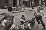 A policewoman plays with local kids in Harlem, New York City, USA, 1978