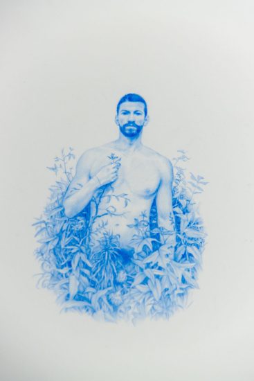 A drawing of a nude man surrounded by plants.