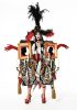 This is a photograph of a person wearing an elaborate costume in front of a white paper backdrop.