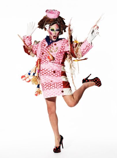 Click for sizes / editions / prices. This is a photograph of a person in a pink outfit in front of a white background.
