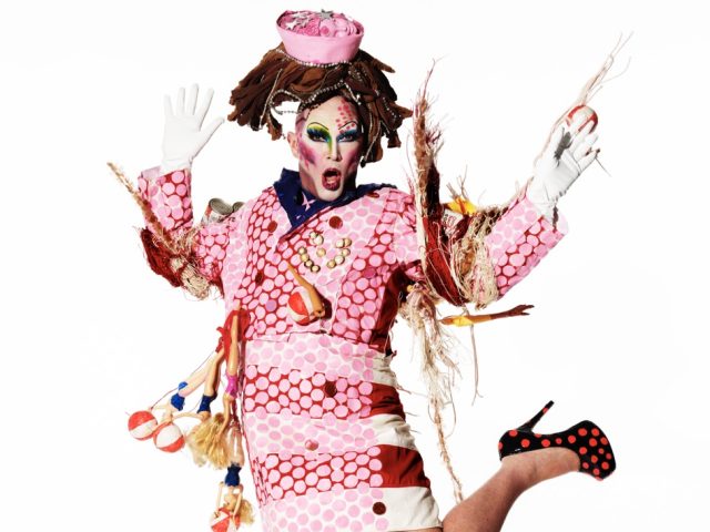 Click for sizes / editions / prices. This is a photograph of a person in a pink outfit in front of a white background.
