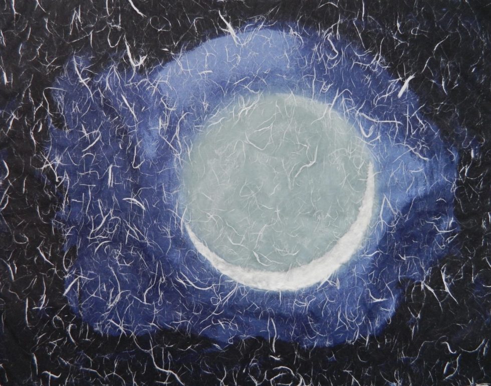 This is an image of a grey orb in a textured blue background.