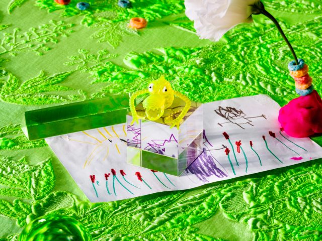 This is a photograph of various colorful objects on a green sheet.