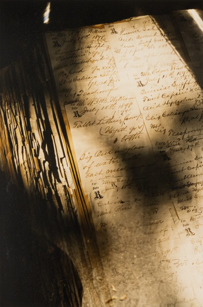 This is a photograph of an ancient book in golden sun light.