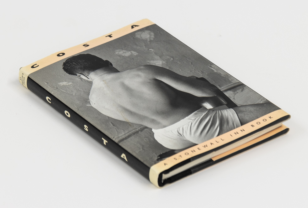 This is a photograph of a small photography book resting on a white surface.