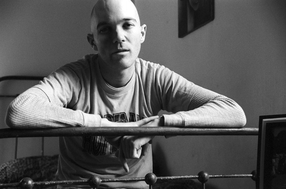 This is a black and white portrait of a bald man.