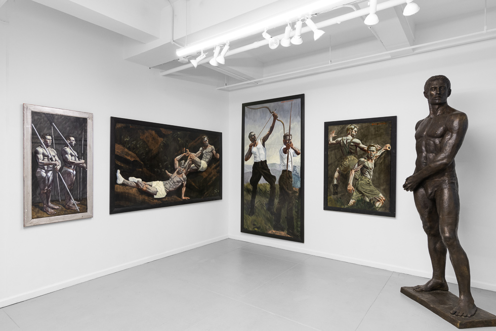An art gallery installation featuring featuring paintings on a white wall.