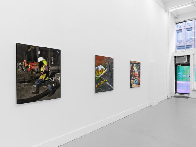 A modern art gallery displays a vintage orange advertisement alongside other artworks, possibly with a Florida theme.