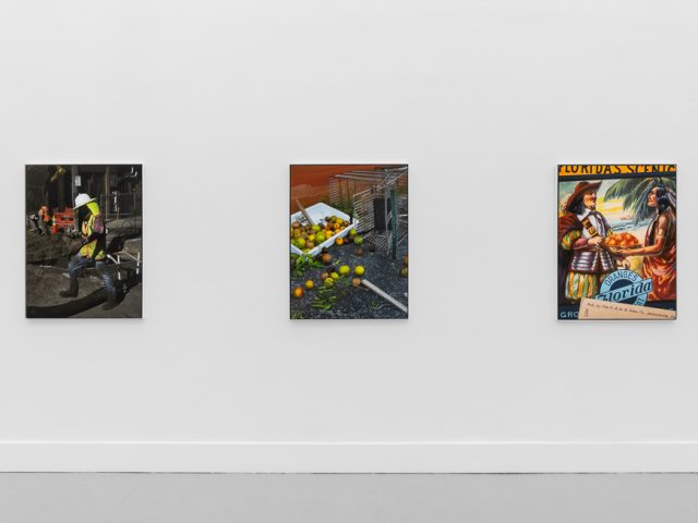 A modern art gallery displays a vintage orange advertisement alongside other artworks, possibly with a Florida theme.