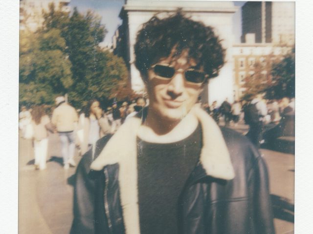 Click for sizes / editions / prices. A polaroid of a handsome young man with a leather jacket, curly hair, and sunglasses.