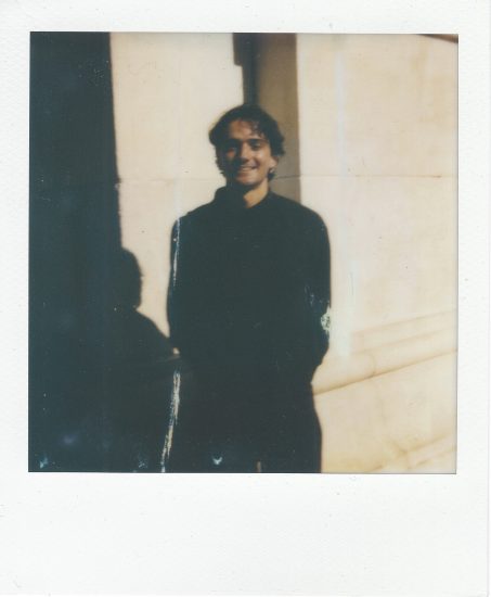 Click for sizes / editions / prices. A polaroid of a young man in a black sweatshirt with dark hair smiling.