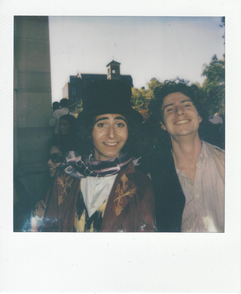 A polaroid of two young men with dark curly hair.