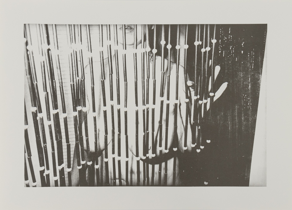 Nude Figure behind beaded curtain.