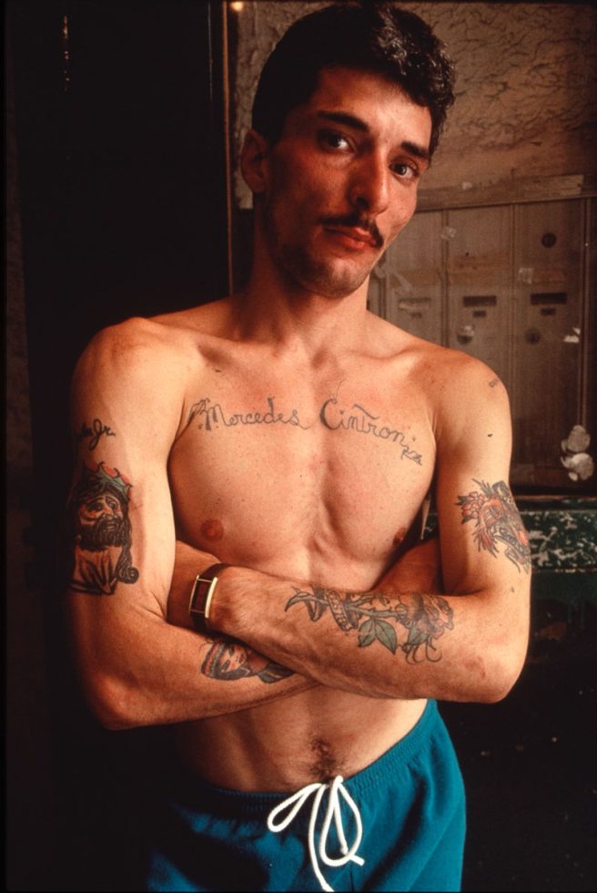 A color photograph of a man with tattoos.