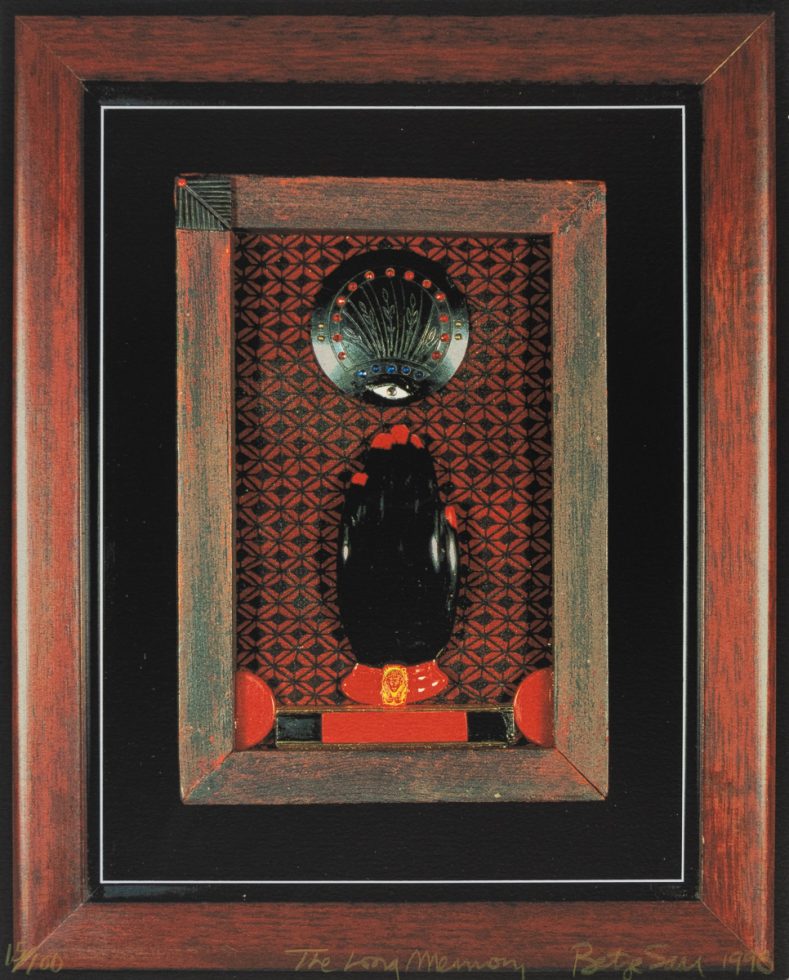A mixed-media assemblage by Betye Saar featuring a totemic black form, a mystical eye motif, and geometric patterns within a rustic wooden frame.
