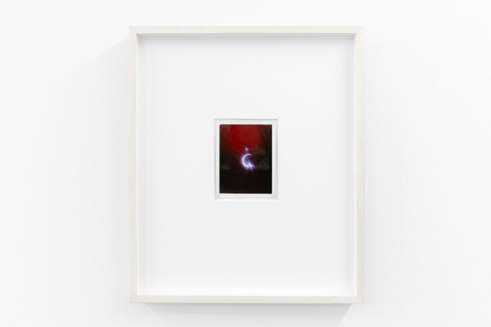 An installation view in a bright, white-walled contemporary art gallery.