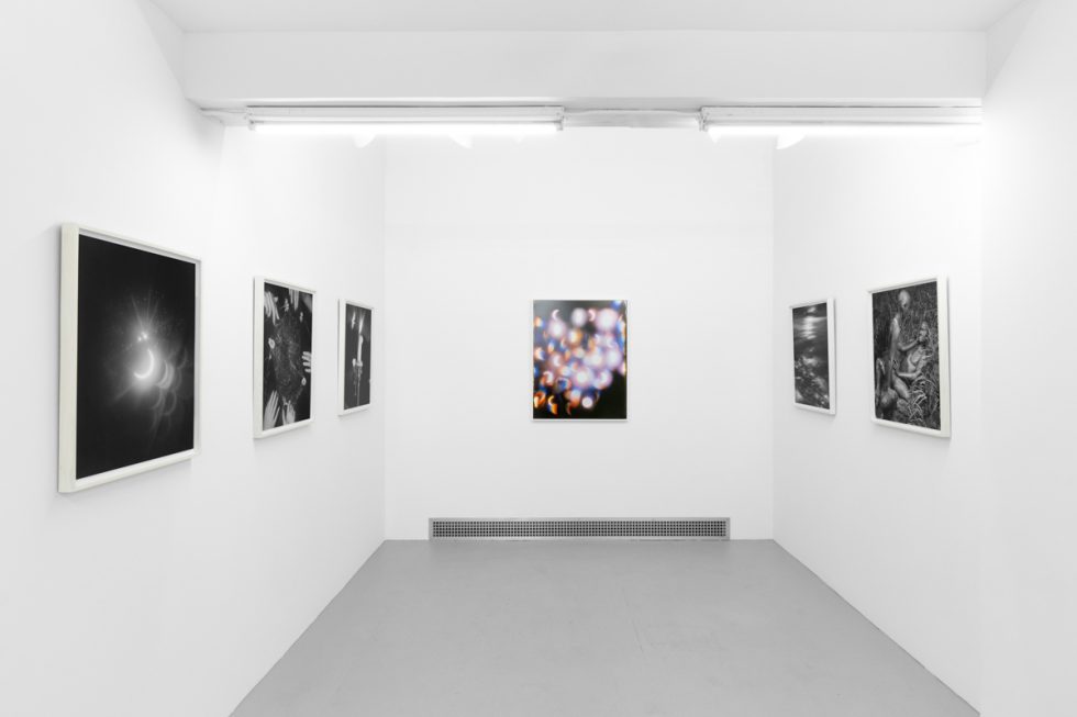 An installation view in a bright, white-walled contemporary art gallery.