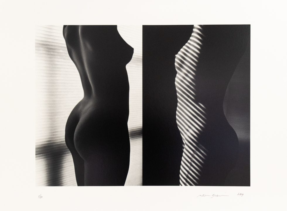A black and white photograph of a nude female torso take in two different lighting situations.