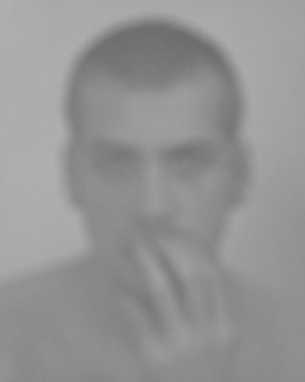 Click for sizes / editions / prices. A black and white photograph of a man's face imaged in a soft focus.