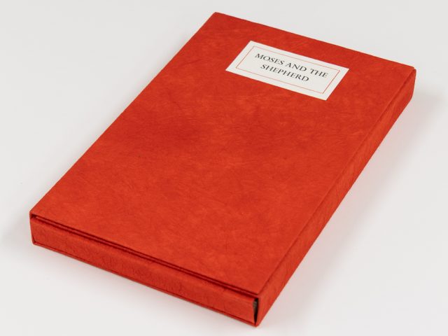 A red book sits on a white background.