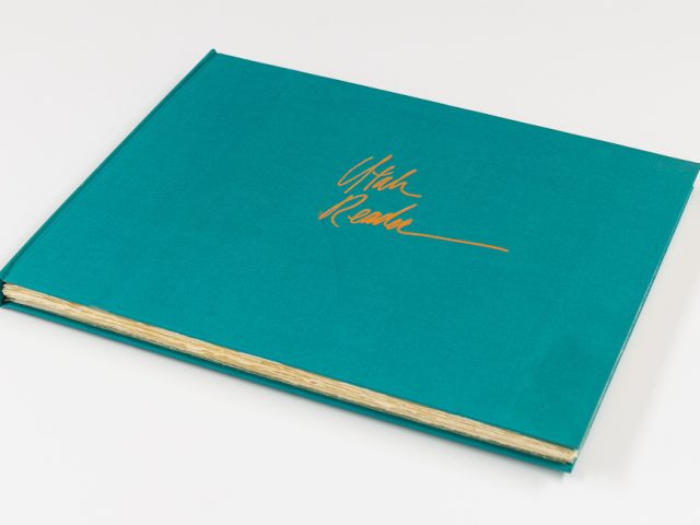 A blue book sits on a white background.
