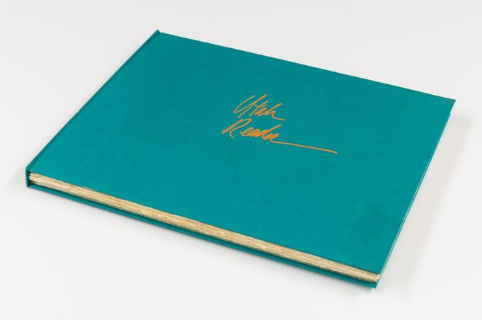 A blue book sits on a white background.