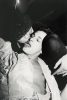 Couple Kissing holding cigarettes