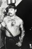 Shirtless Tattooed Man with Bird and Stick