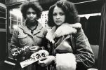 Two Women holding photo strips