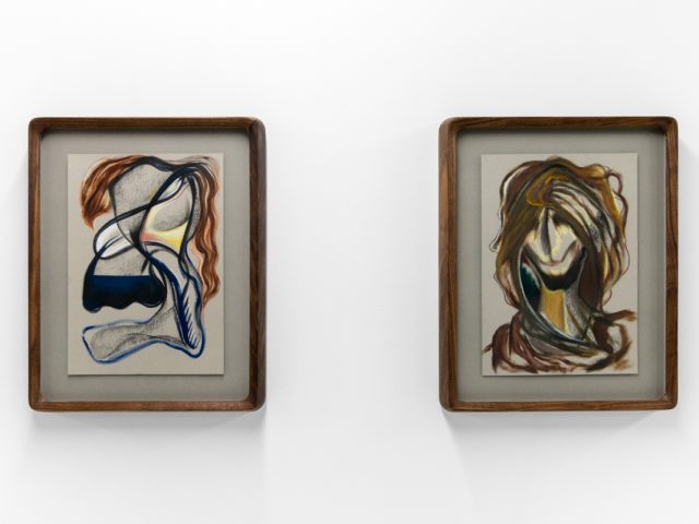 A series of abstract framed drawings hang on a white gallery wall under a black and white artist name and exhibition title.