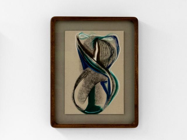 A series of abstract framed drawings hang on a white gallery wall under a black and white artist name and exhibition title.