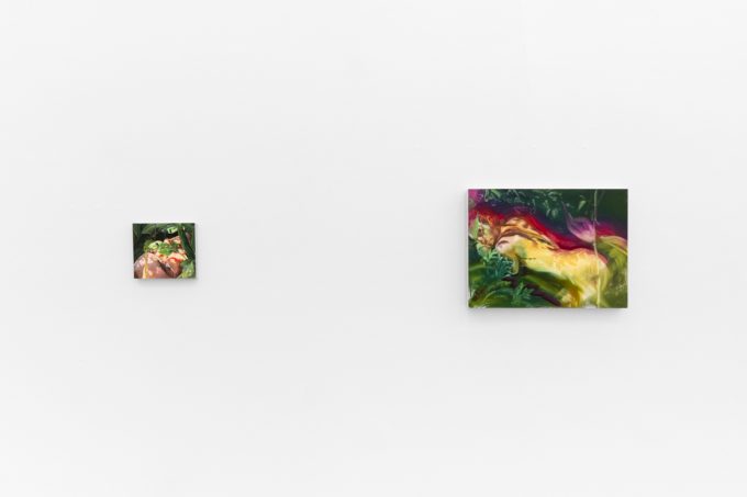 Two colorful paintings depict figures and flowers in lush, dreamlike environments with saturated greens, yellows, and reds on a white wall.