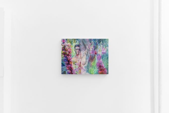 A vibrant painting shows a semi-nude figure among lush, surreal plants in shades of pink, green, and purple on a white gallery wall.