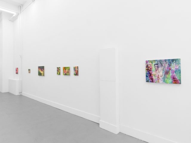 Colorful abstract paintings hang on a white gallery wall, ending with a larger piece featuring a surreal scene with a semi-nude figure.