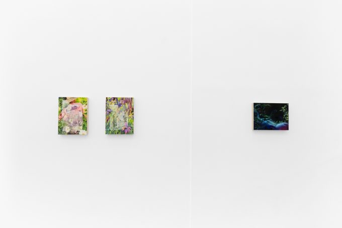 Colorful artworks on a bright white gallery wall in neutral lighting.