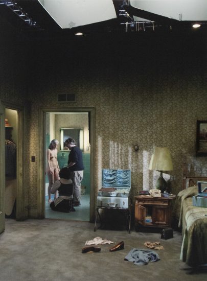 A photograph of 3 people in a bathroom.