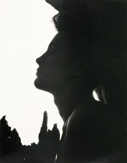 Silhouetted profile of a man with closed eyes, framed by jagged shadows and a stark white background.