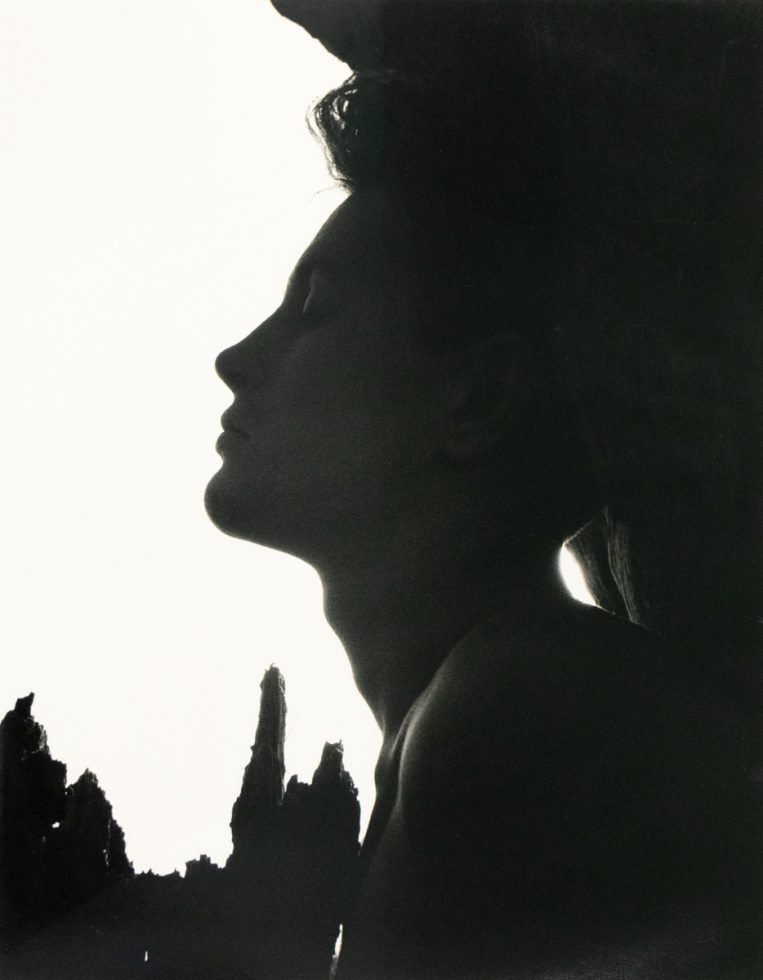 Silhouetted profile of a man with closed eyes, framed by jagged shadows and a stark white background.