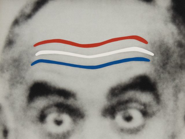 A black and white image of a man's eyebrows raised with a red white and blue lines.