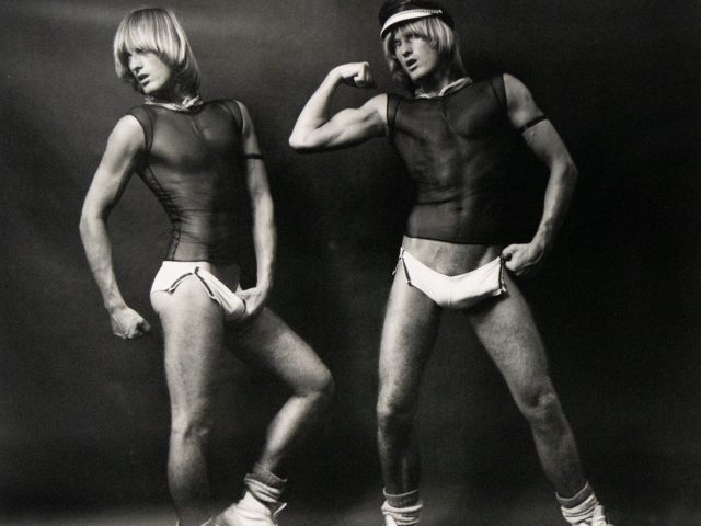 Two figures with similar features, one in a head covering, display athletic forms in striking poses against a plain background.