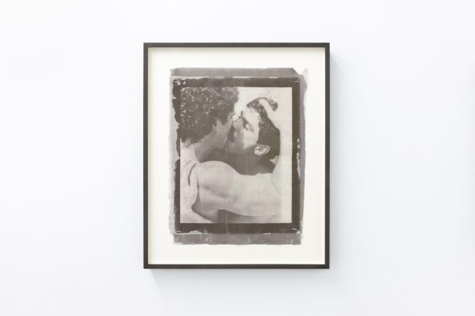 Contemporary artworks displayed along stark white bright gallery walls.