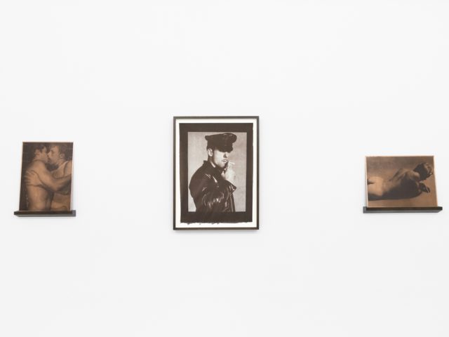 Contemporary artworks displayed along stark white bright gallery walls.