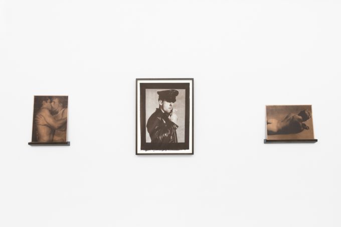 Contemporary artworks displayed along stark white bright gallery walls.