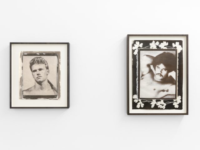 Contemporary artworks displayed along stark white bright gallery walls.