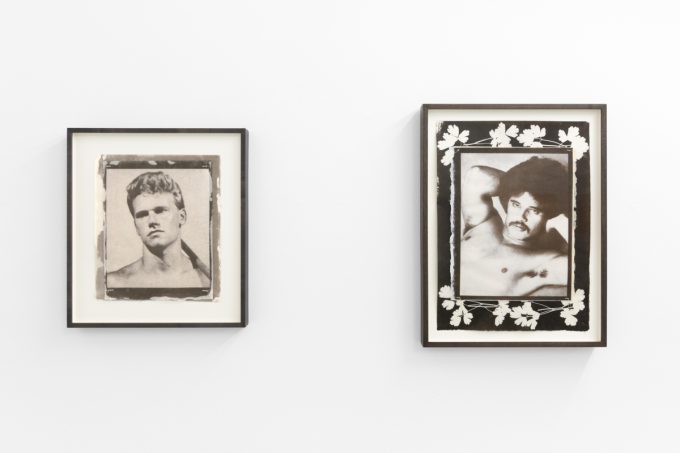 Contemporary artworks displayed along stark white bright gallery walls.